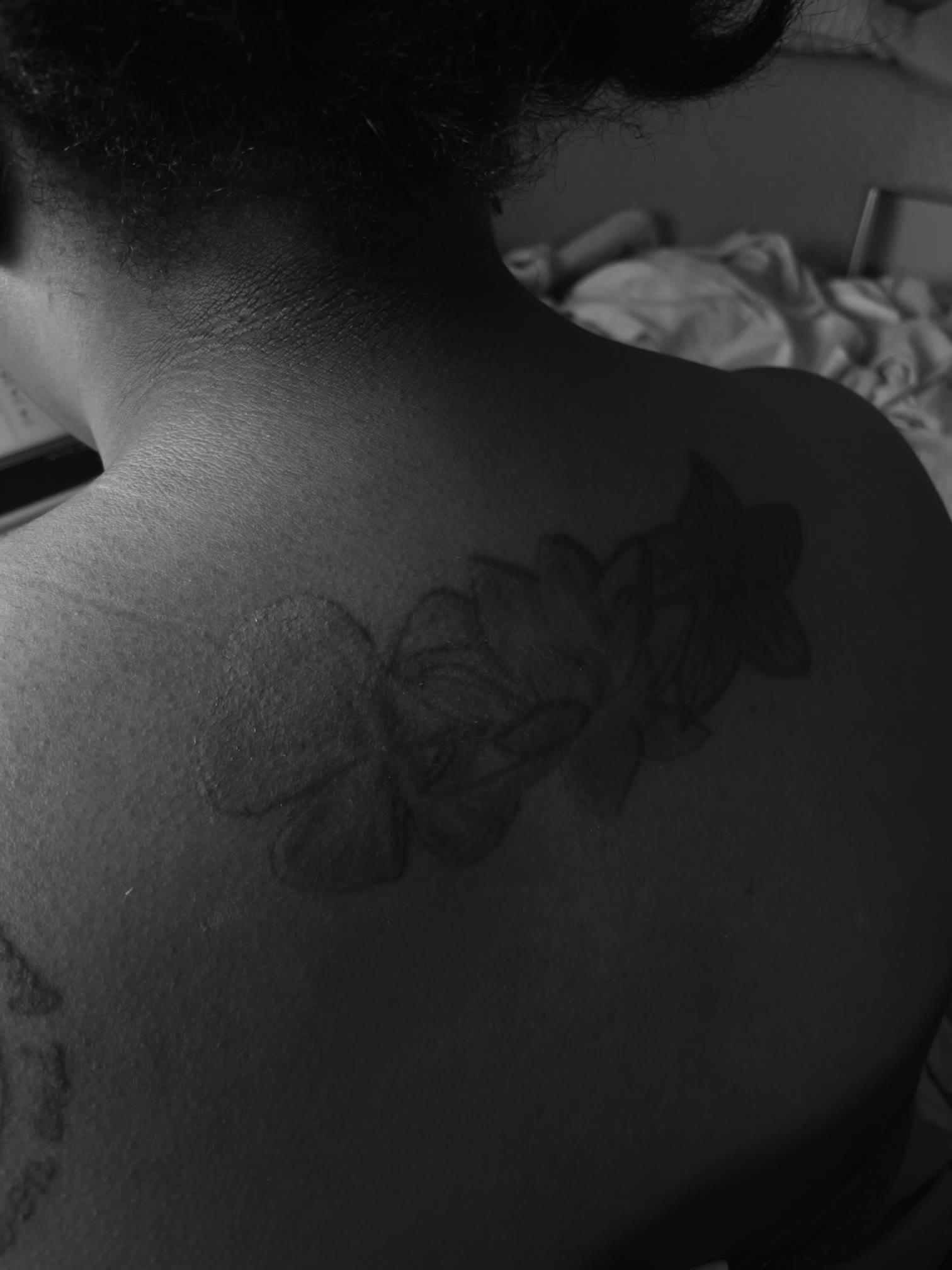 Floral shoulder tattoo before makeup coverage