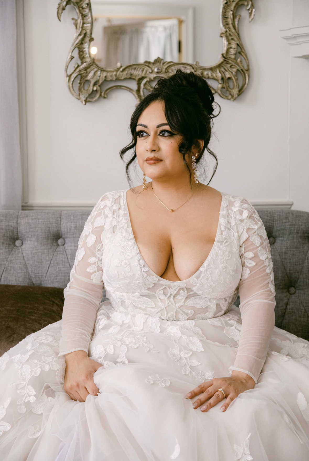Bride in lace gown with soft glam bridal makeup and updo