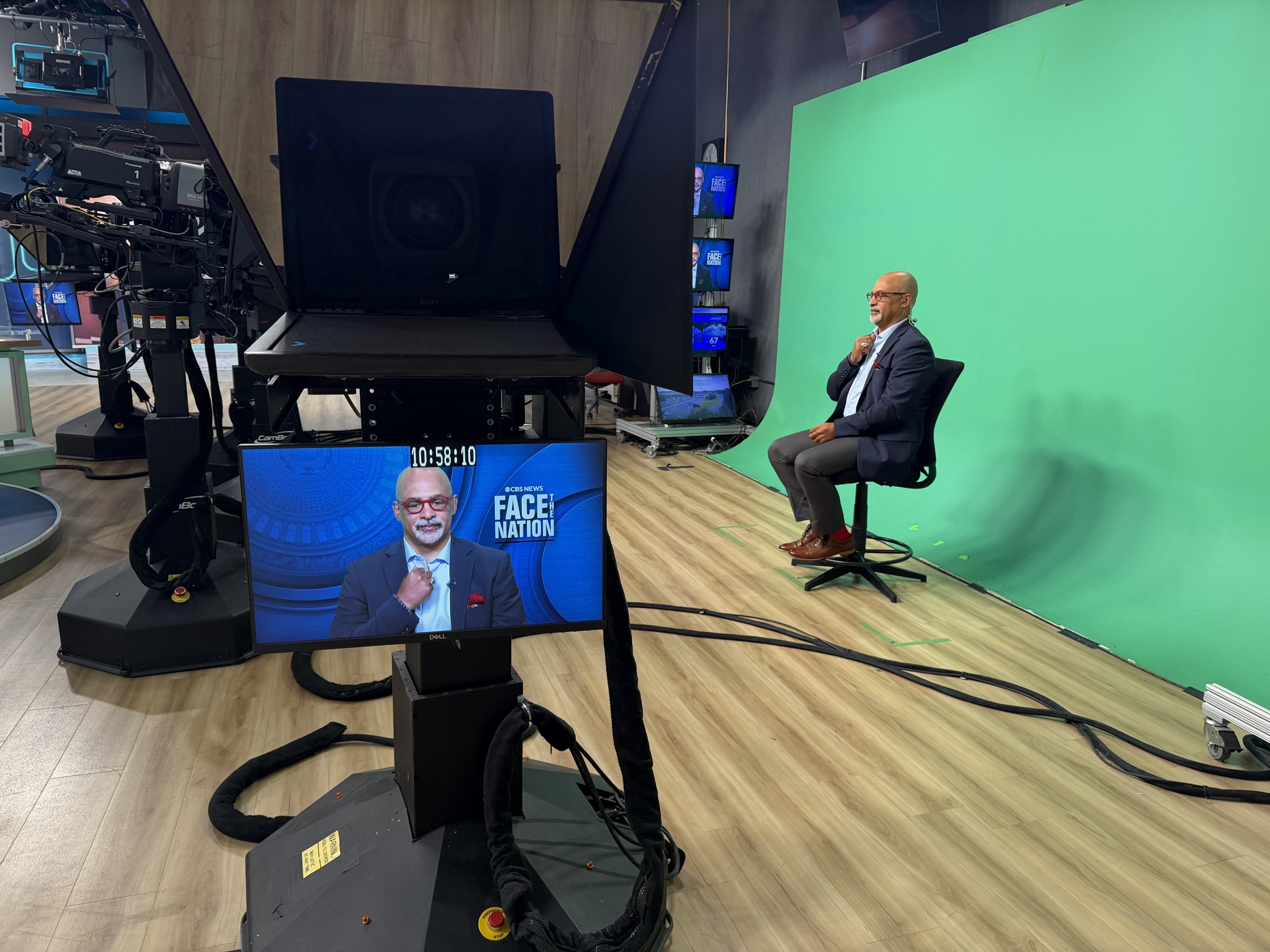 Broadcast studio green screen set with talent seated for a live interview