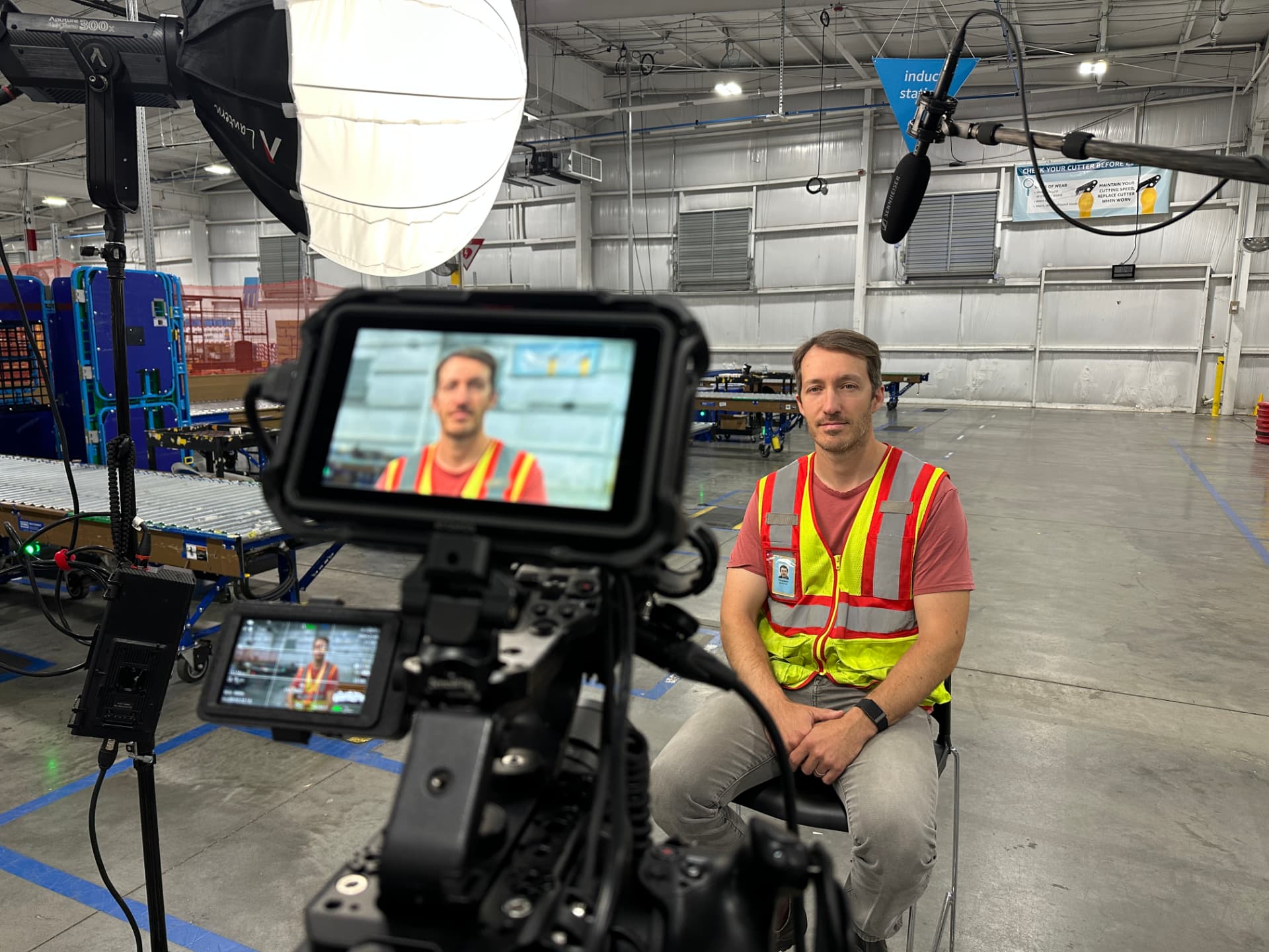 Behind-the-scenes on-set interview setup in an industrial warehouse