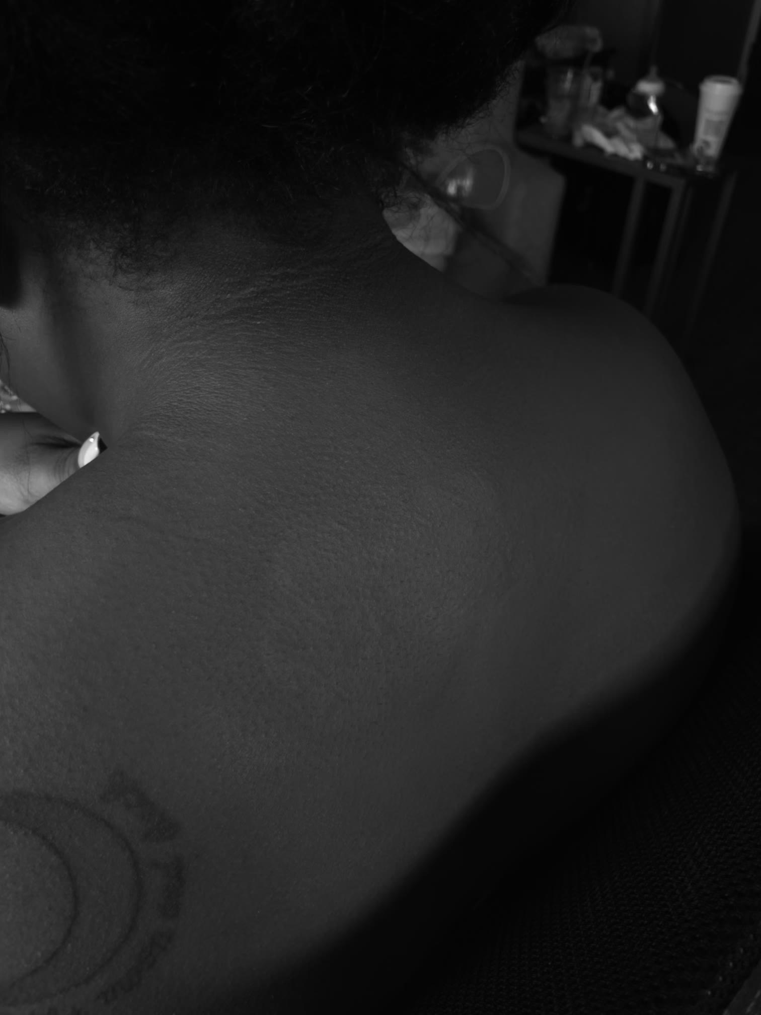 Floral shoulder tattoo fully concealed with makeup