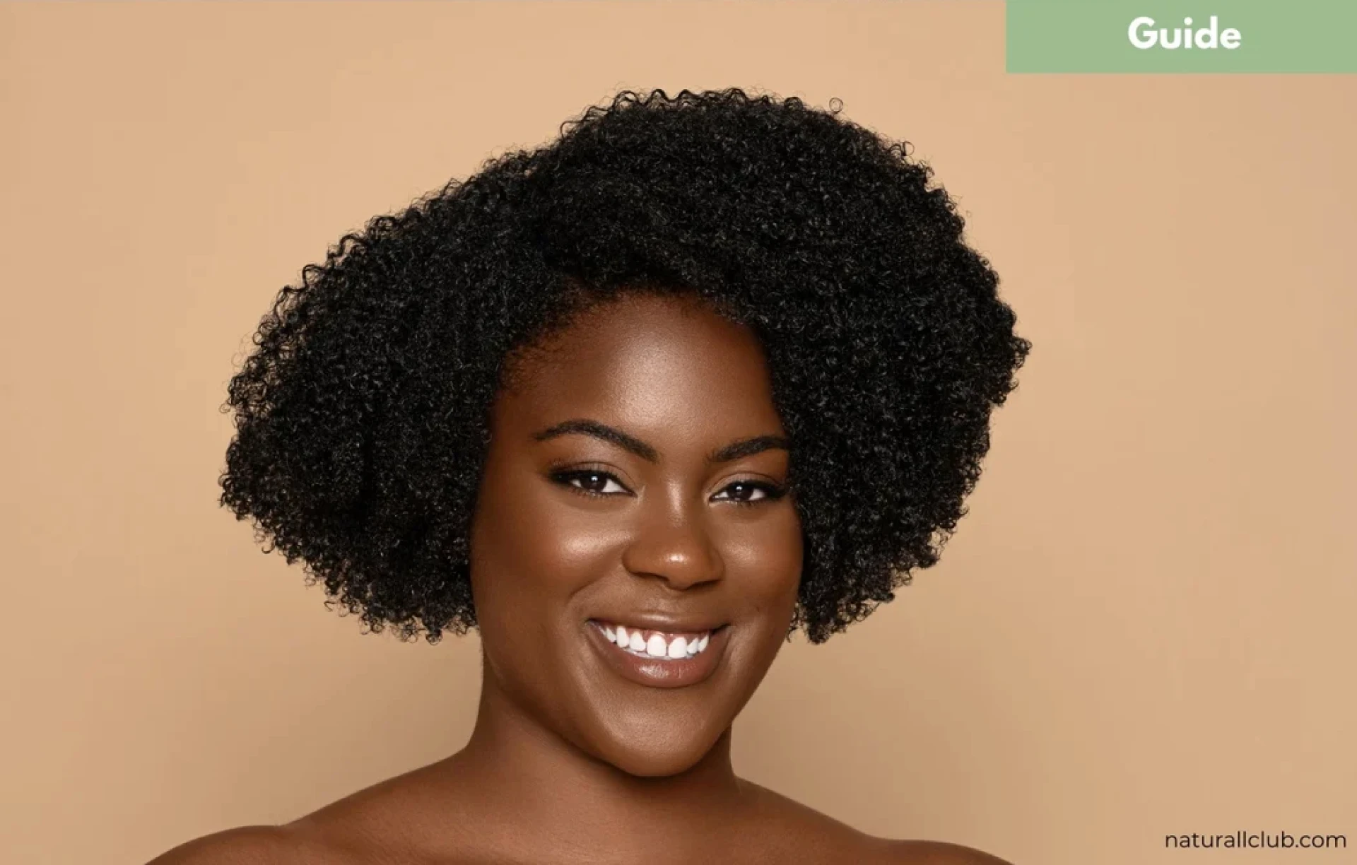 Commercial beauty portrait of a smiling woman with natural curly hair