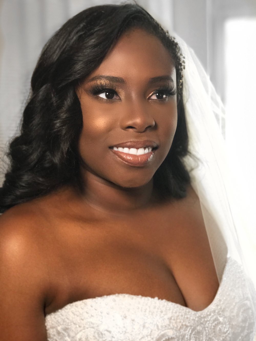 Bride in veil with warm bronze bridal makeup
