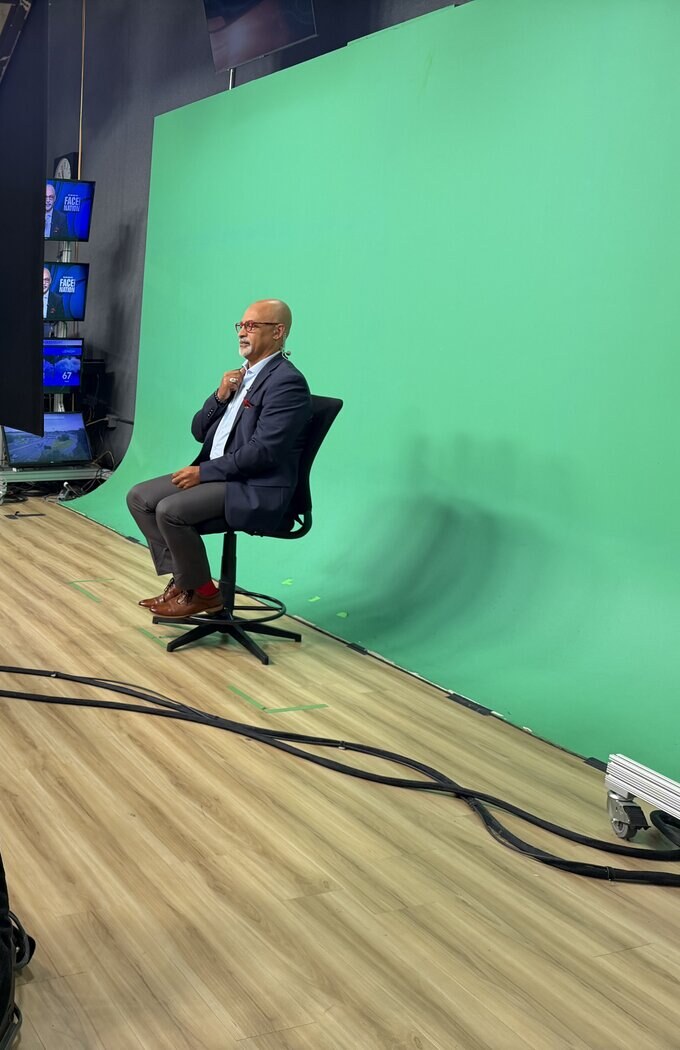 Broadcast studio set with male talent groomed for a news segment